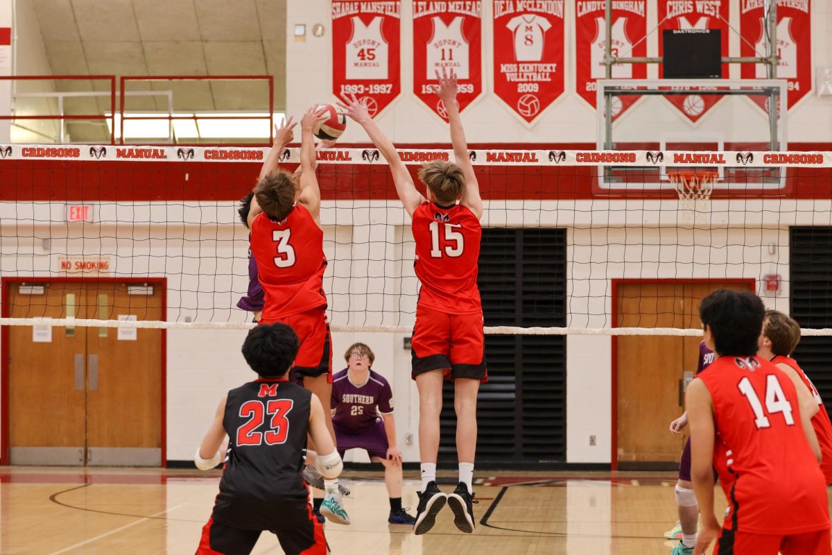 Seth Niemann (#3, 11) and Cooper Boehm (#15, 10) trying to block the ball.
