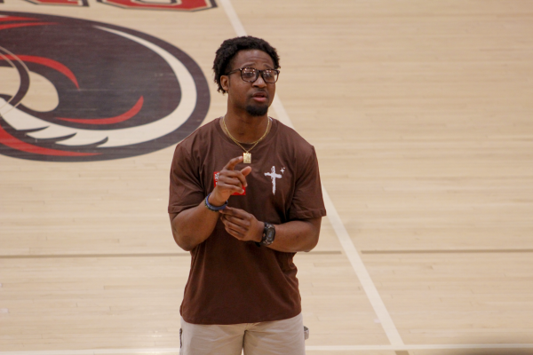 Former collegiate running back Perris Jones speaks to Manual students about his journey with athletics, faith and perseverance during the April 22 Crimson Hour.