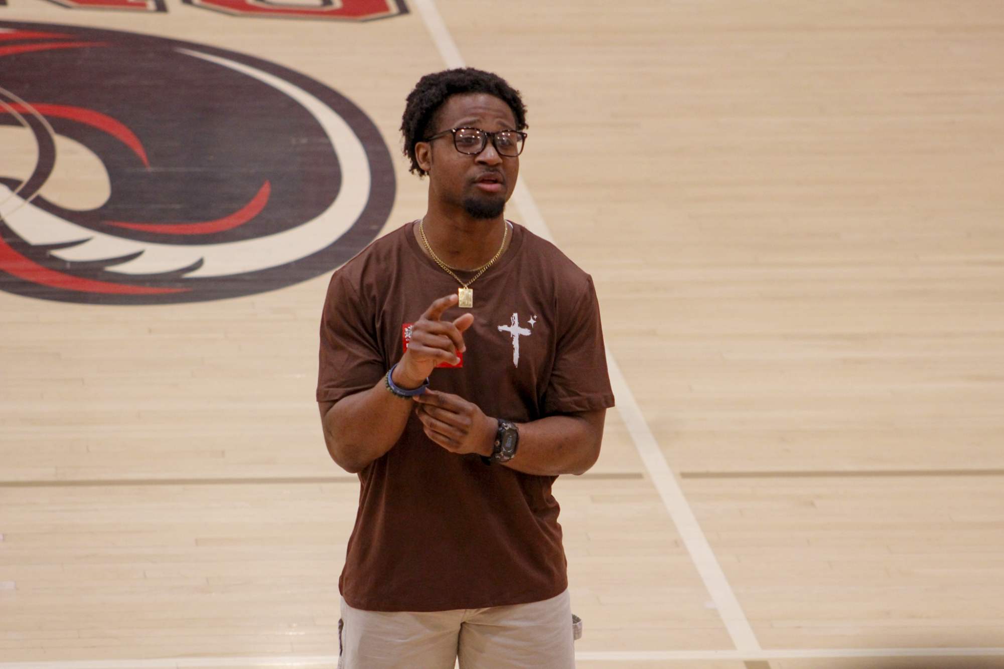 Former collegiate running back Perris Jones speaks to Manual students about his journey with athletics, faith and perseverance during the April 22 Crimson Hour.