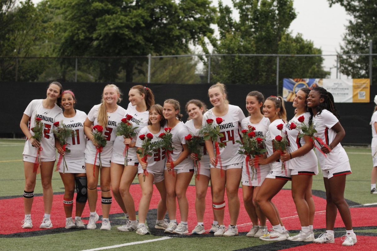 Manual's senior girls' lacrosse players stand together for a photo after the senior ceremony.